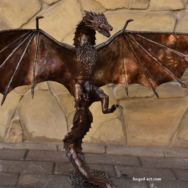 A forged stainless steel dragon with unfolded wings