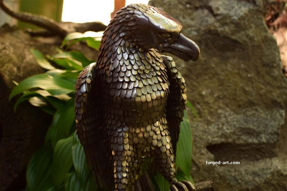 An eagle sitting on a tree - a beautiful sculpture made of stainless steel - photo 11