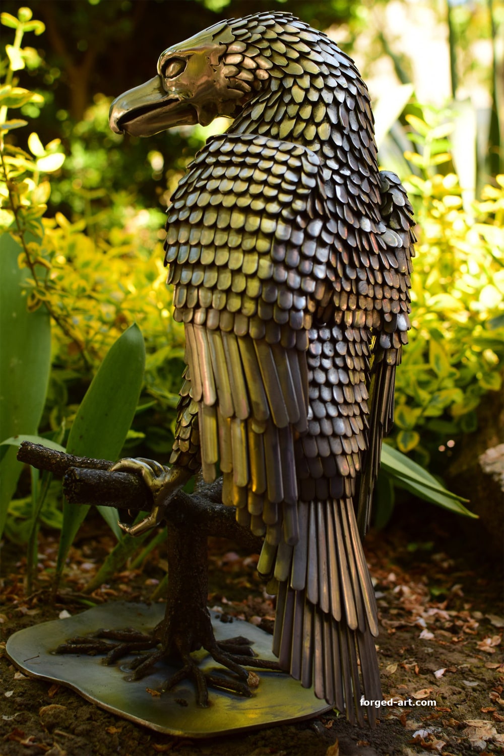An eagle sitting on a tree - a beautiful sculpture made of stainless steel - photo 8