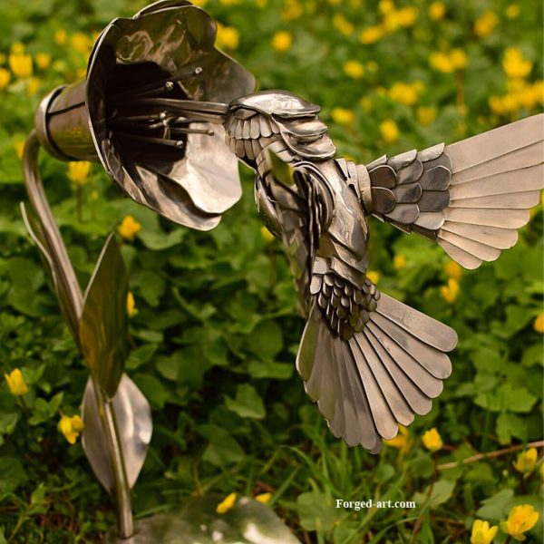 Kolibri trinkt Nektar aus einer Blüte, Figur aus poliertem Edelstahl