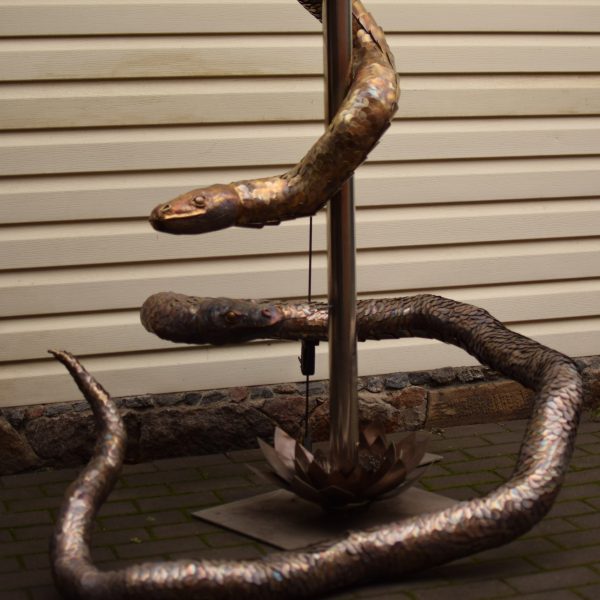 Heat-tinted steel snakes coiling around a pole